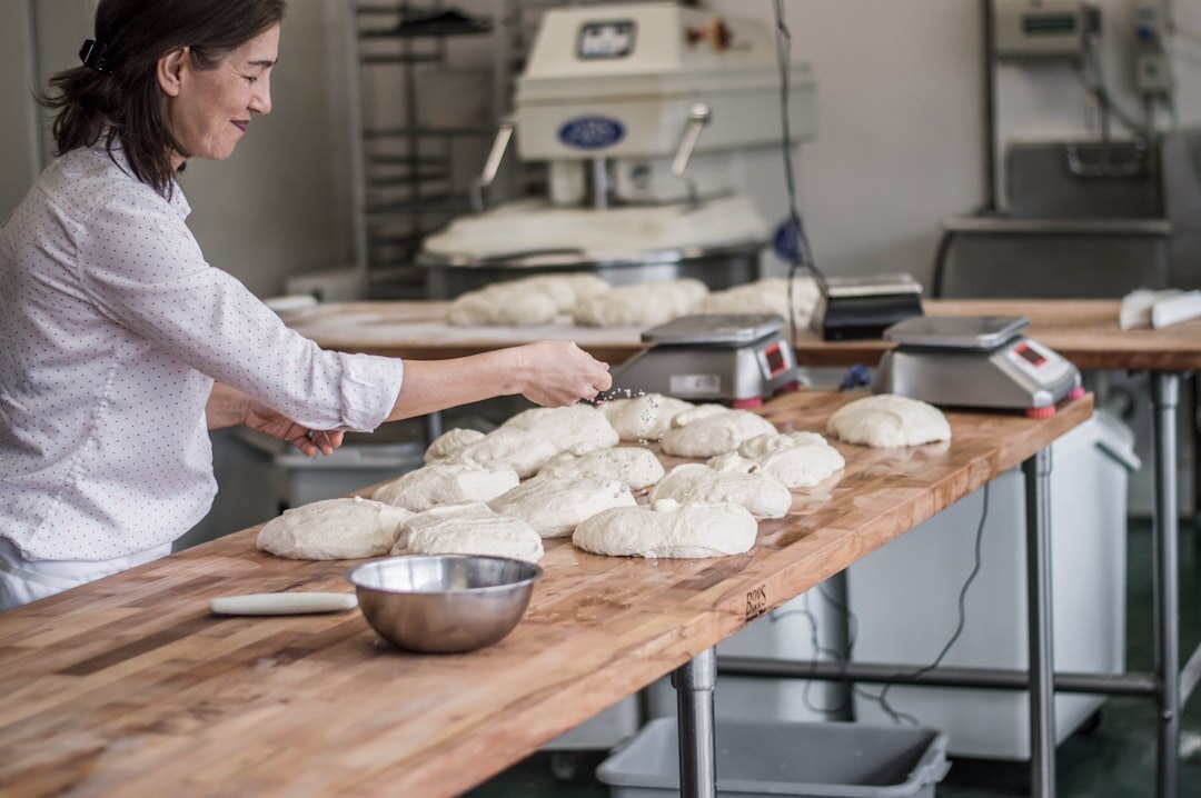 Czech woman kneading dough for buchty in a home kitchen